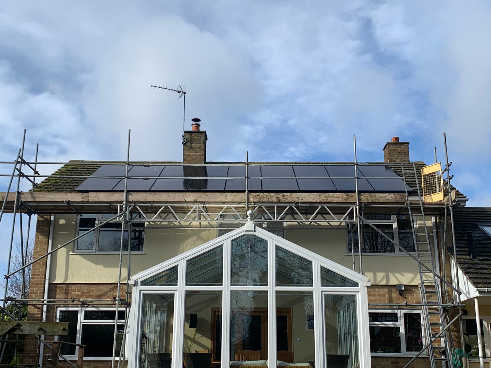 solar panel installation on roof with scaffolding
